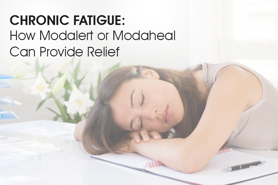 Tired woman sleeping on desk, symbolizing chronic fatigue relief with Modalert or Modaheal.
