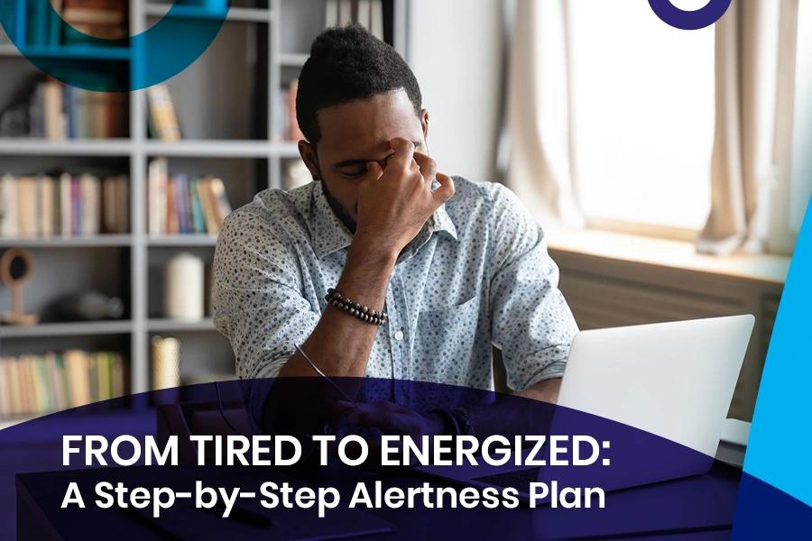 Man feeling tired at desk with laptop – From Tired to Energized: A Step-by-Step Alertness Plan