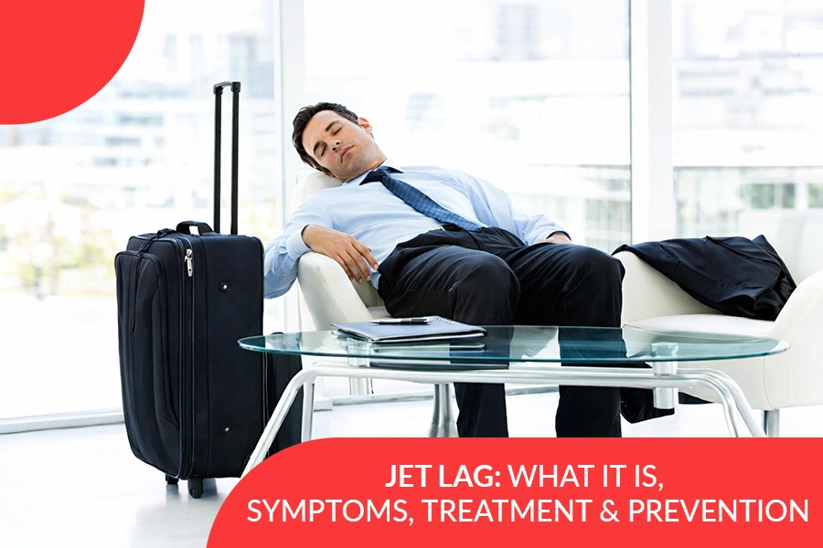 Businessman asleep on a chair at an airport with a suitcase beside him