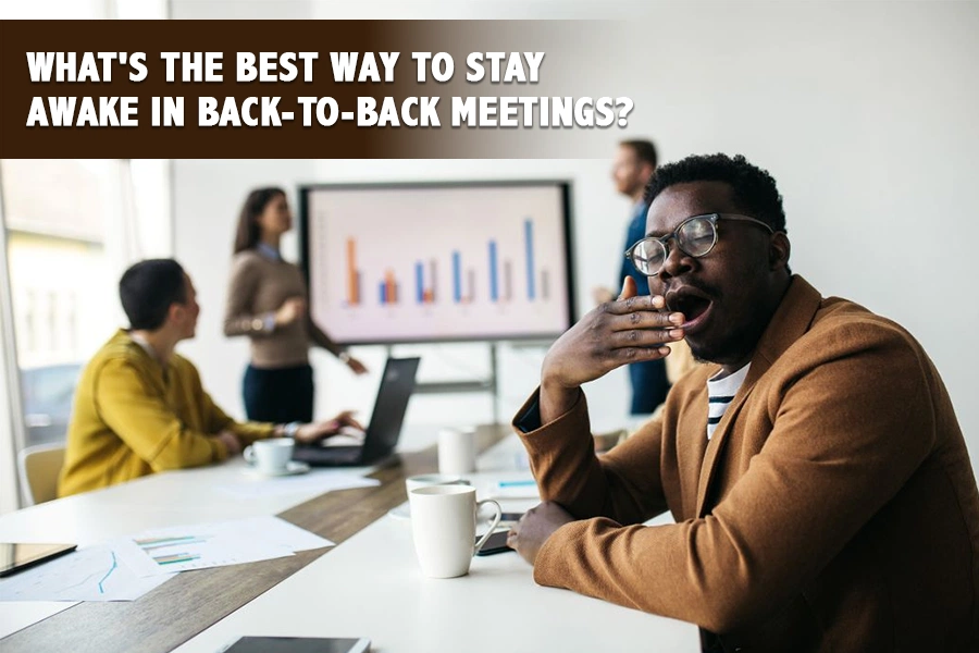 Office professional struggling to stay awake during back-to-back meetings while colleagues present charts in a conference room.