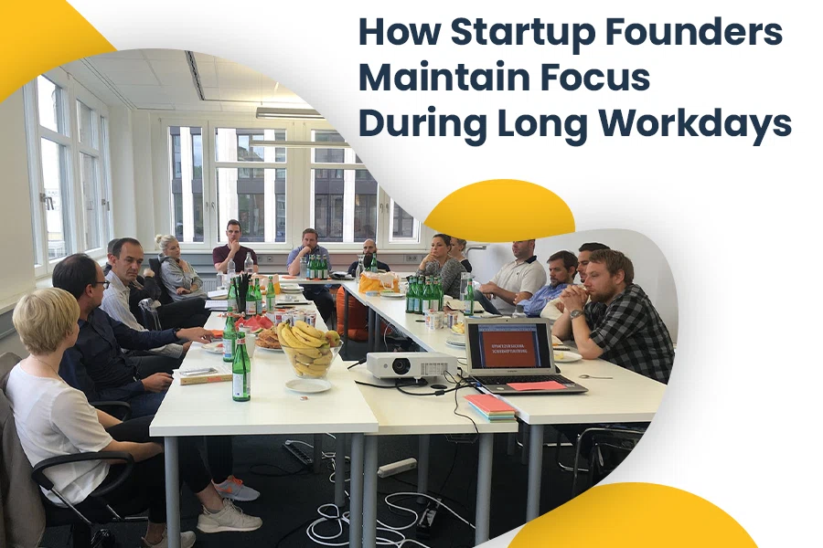 Startup founders sitting around a table during a long workday meeting